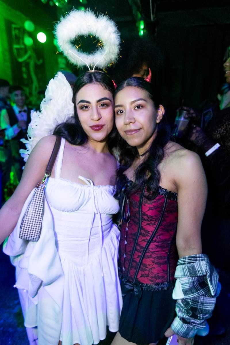 Angel and devil costumes at a Crawlloween venue