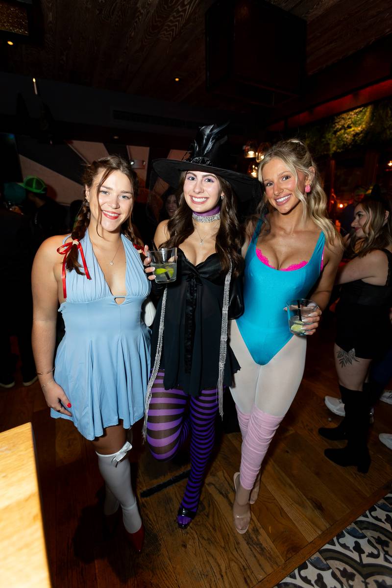 Three attendees in coordinated costumes on the dance floor