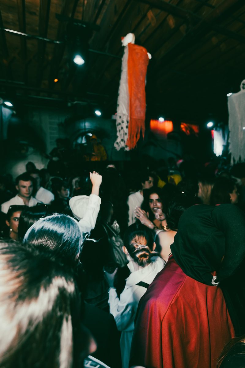 A full room of costumed attendees at a late Crawlloween stop