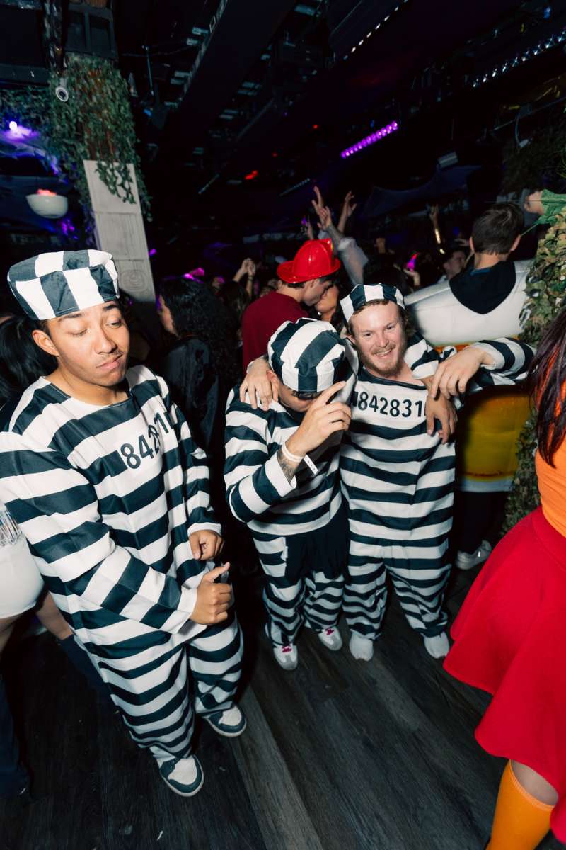 A costumed group dancing together at a Crawlloween venue