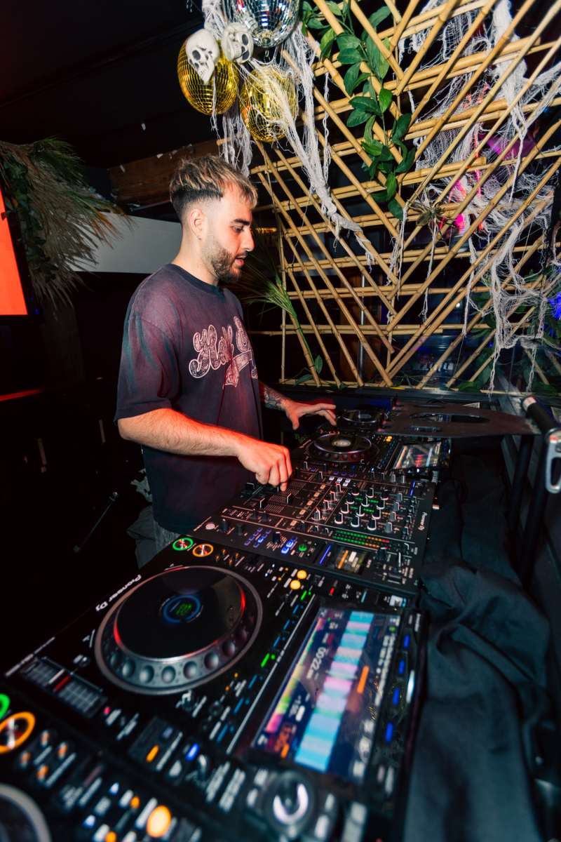 A DJ working the decks on Halloween night
