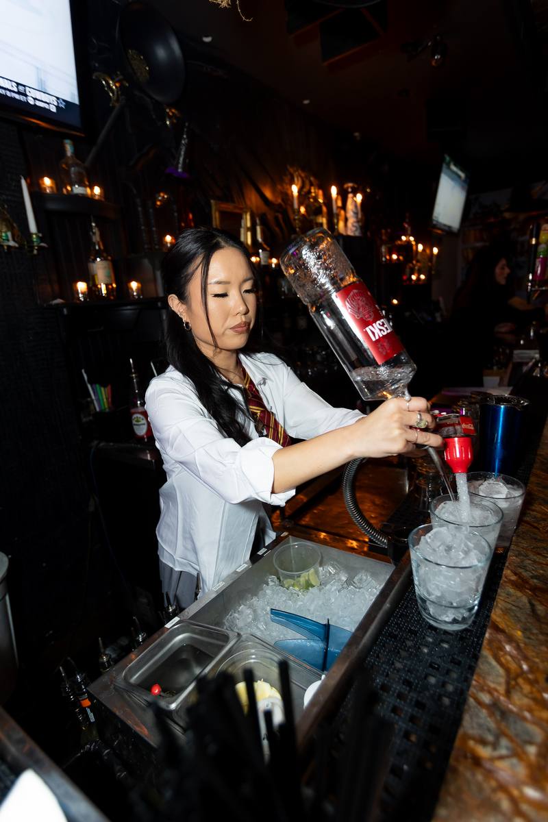 A bartender pouring drinks for Crawlloween wristband holders