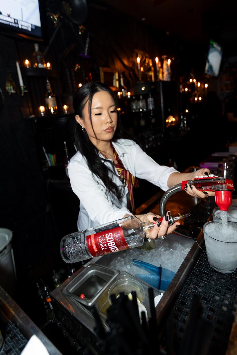 A bartender working the rail during Crawlloween 2025