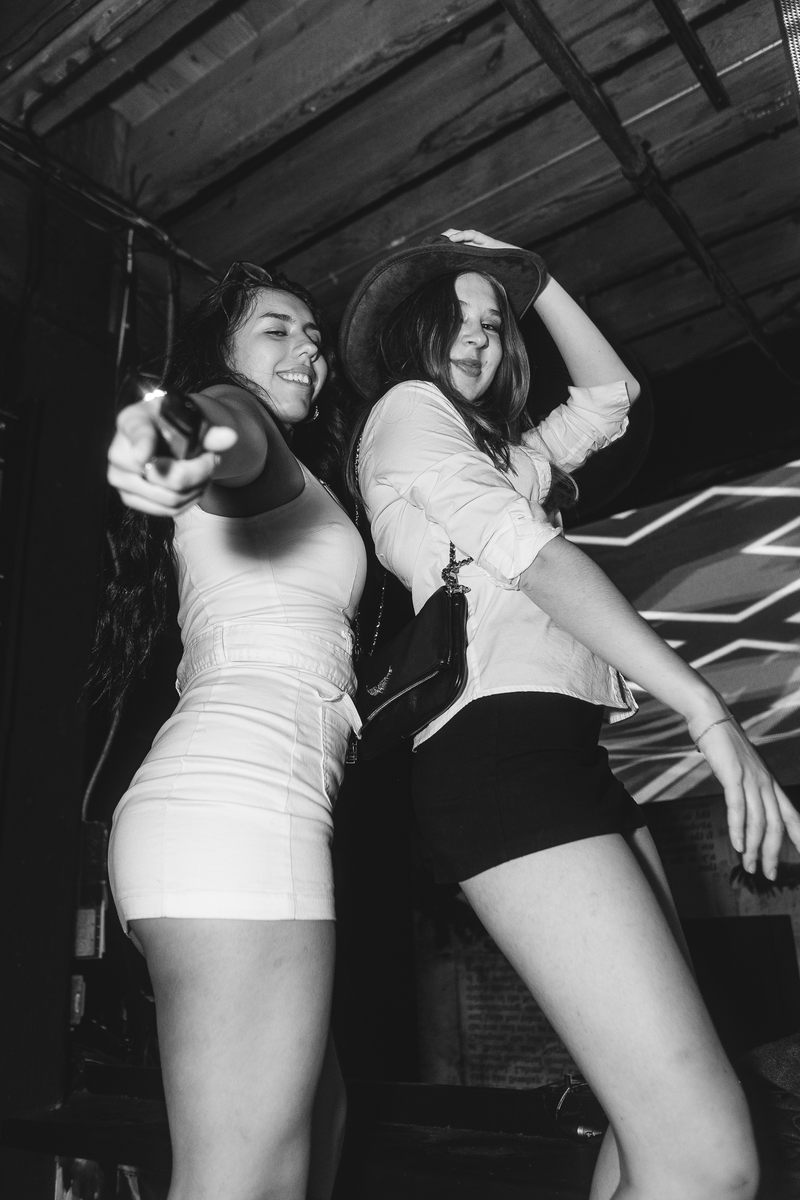 Black and white photograph of two attendees dancing at Crawlloween