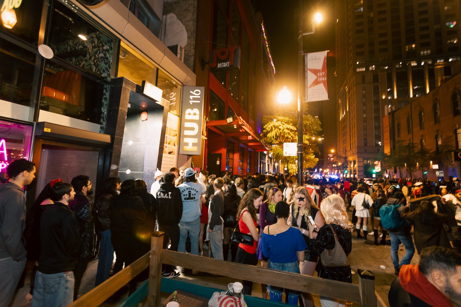 Crawlers walking a River North street at night between Crawlloween venues