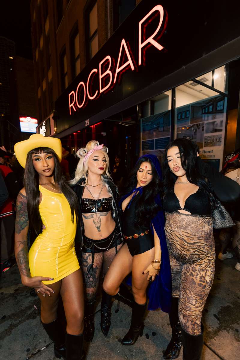 The ROCBAR neon sign on West Hubbard with costumed crawlers outside