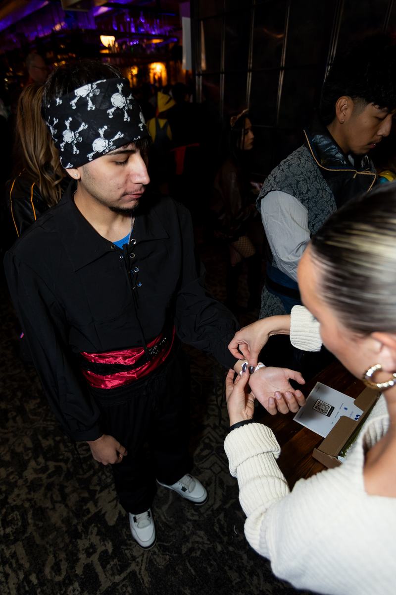 Attendees in costume waiting to collect Crawlloween wristbands
